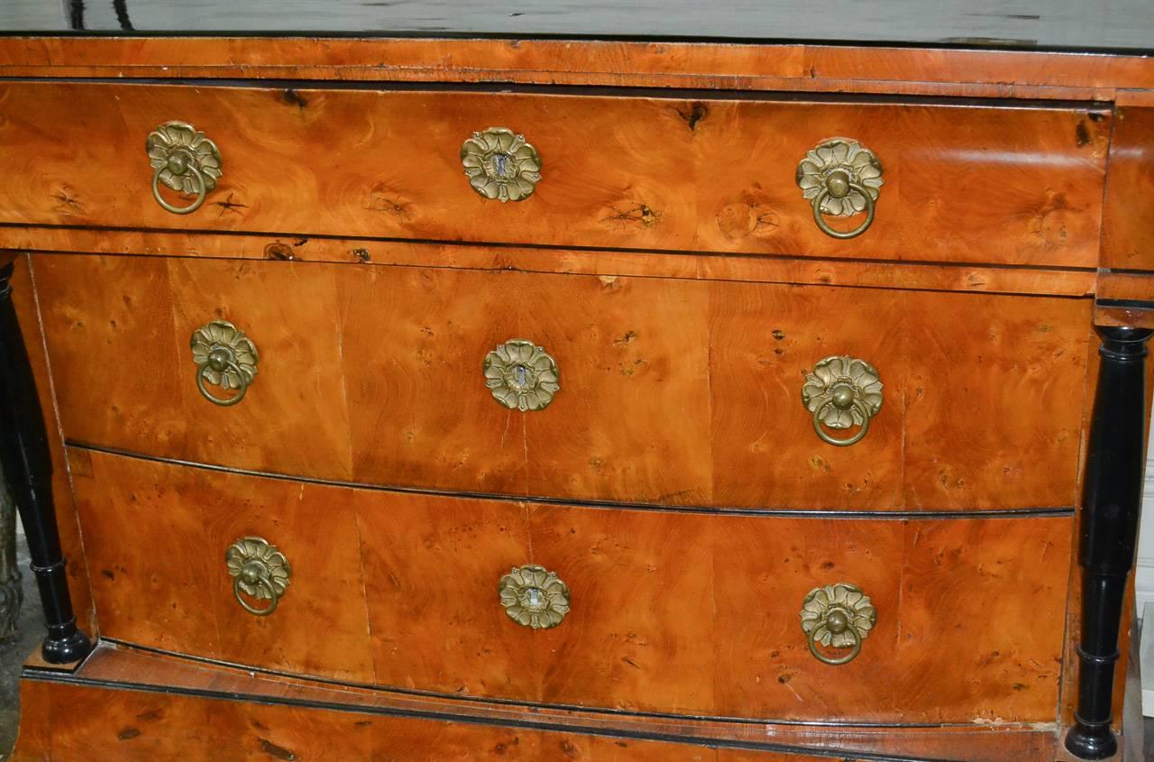 Superb 19th century period Austrian Biedermeier elmwood and black lacquered three-drawer commode. Having wonderful bronze hardware, two lower shaped drawers, and black lacquered columnar supports and top. Exhibiting a beautiful patina and clean