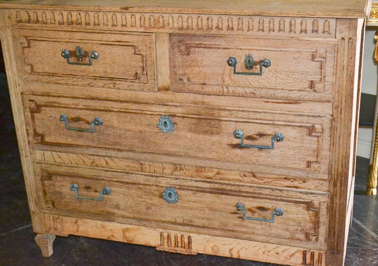 Wonderful 18th century French Louis XVI bleached oak four-drawer commode. Having lovely aged bronze hardware, carved drawer fronts, and fluted detailing. Exhibiting a beautiful bleached finish and clean lines excellent for numerous designs!

