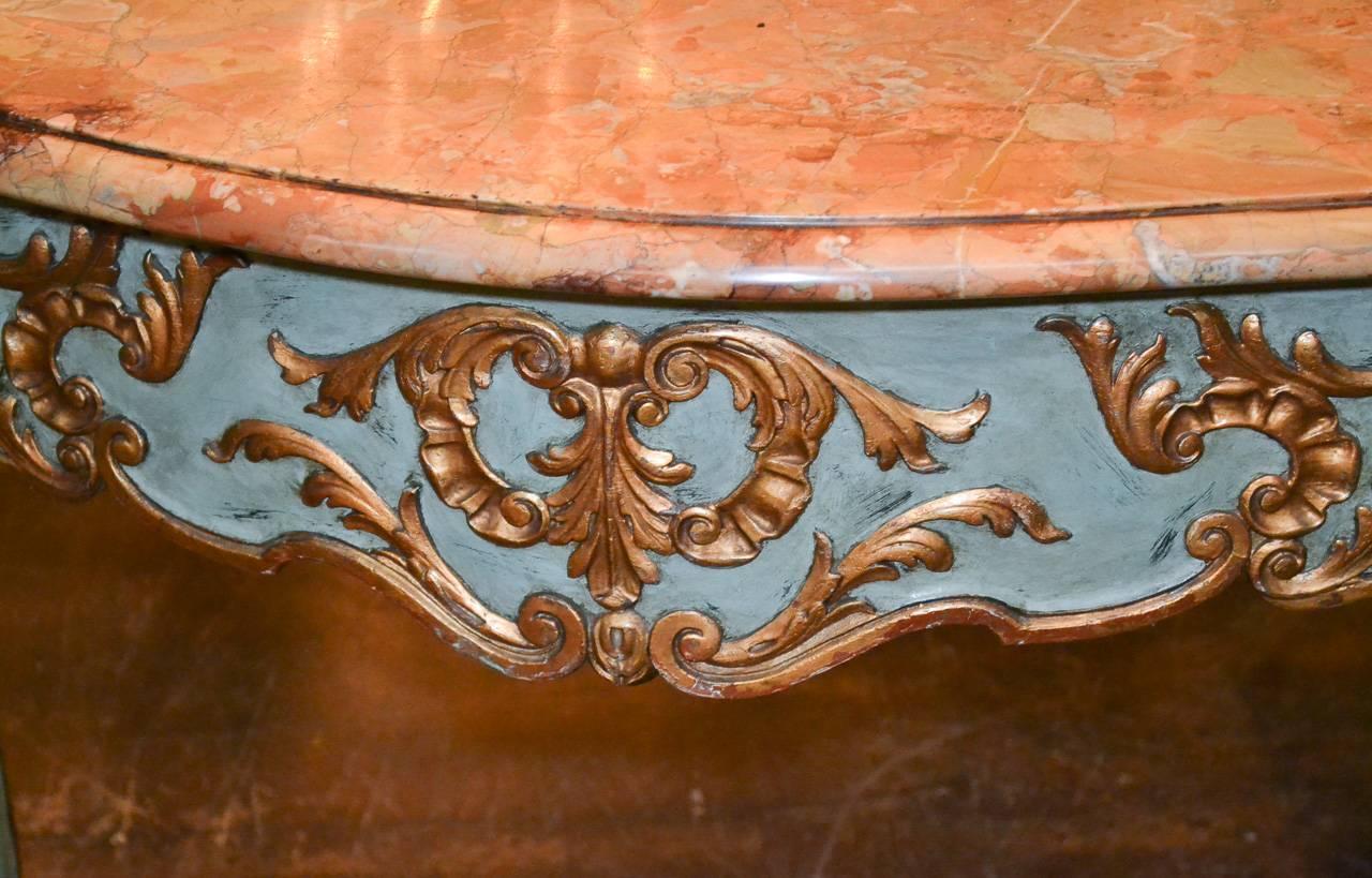 Beautiful 19th century French Louis XVI painted and parcel-gilt console. Having lovely Rouge Alicante marble top, carved parcel-gilt details in acanthus leaf motif, and resting on cabriole legs.
