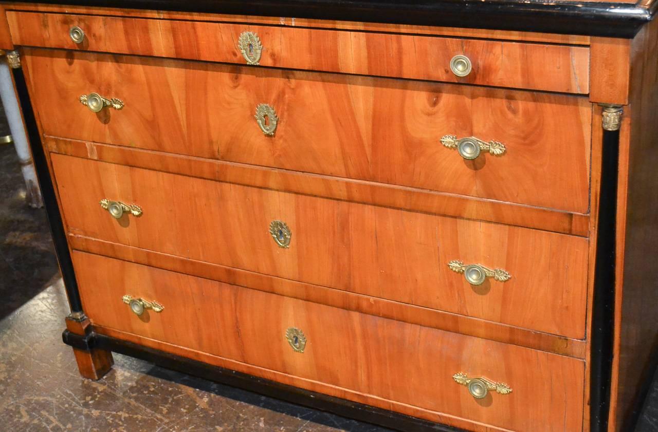 Magnificent 19th century German Biedermeier ebonized birch and cherry three-drawer commode. Having detailed cast bronze hardware, handsome ebonized trim and columnar supports and a rich warm finish. Exhibiting a fabulous patina and clean lines.