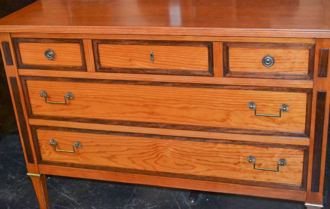 Early 20th century French maple three-drawer commode. Having fabulous warm rich patina, bronze hardware and resting on tapered legs. Featuring crisp lines.