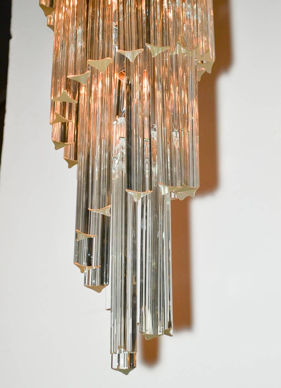 Gorgeous Mid-Century Italian crystal waterfall chandelier. Having beautiful spiraling form and adorned large elongated crystal prisms. 