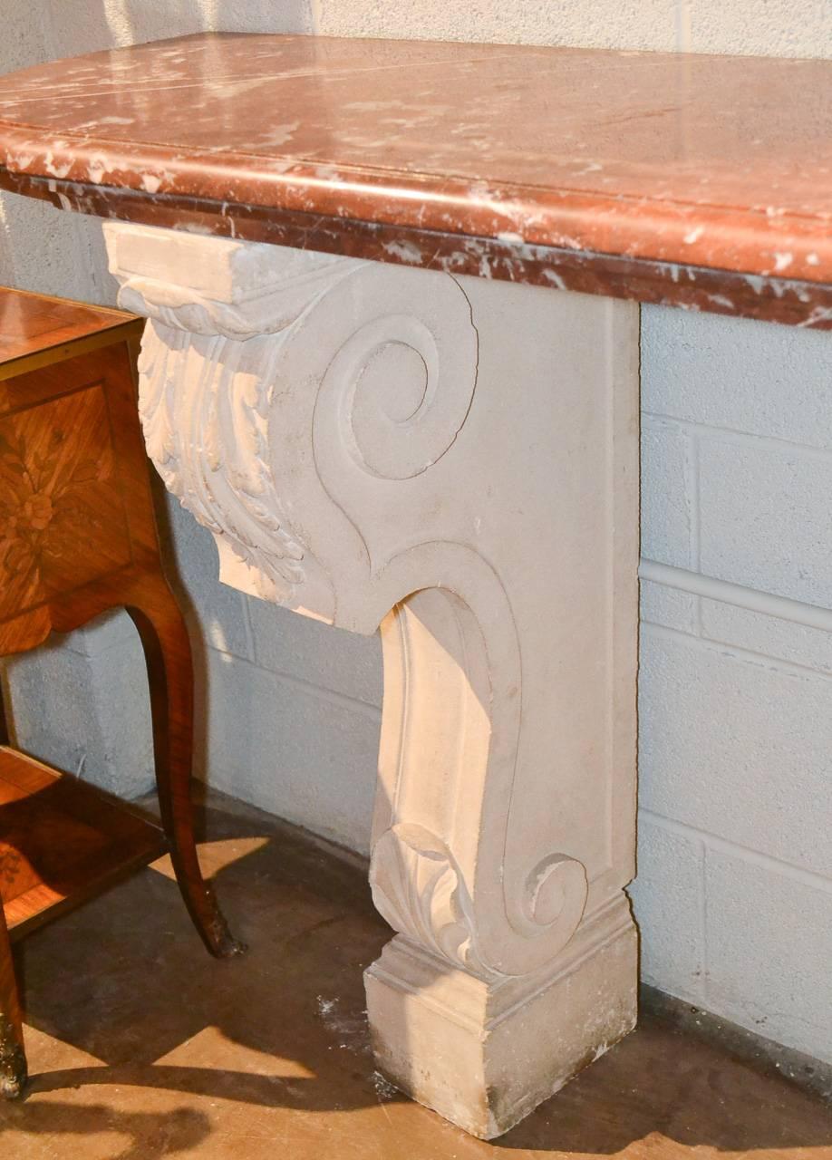 Wonderful 19th century French carved limestone console with beautiful, thick Rouge du Languedoc marble top. Having lovely carved limestone legs in scrolling shape accented with acanthus leaf motif. An attractive piece with Classic lines.