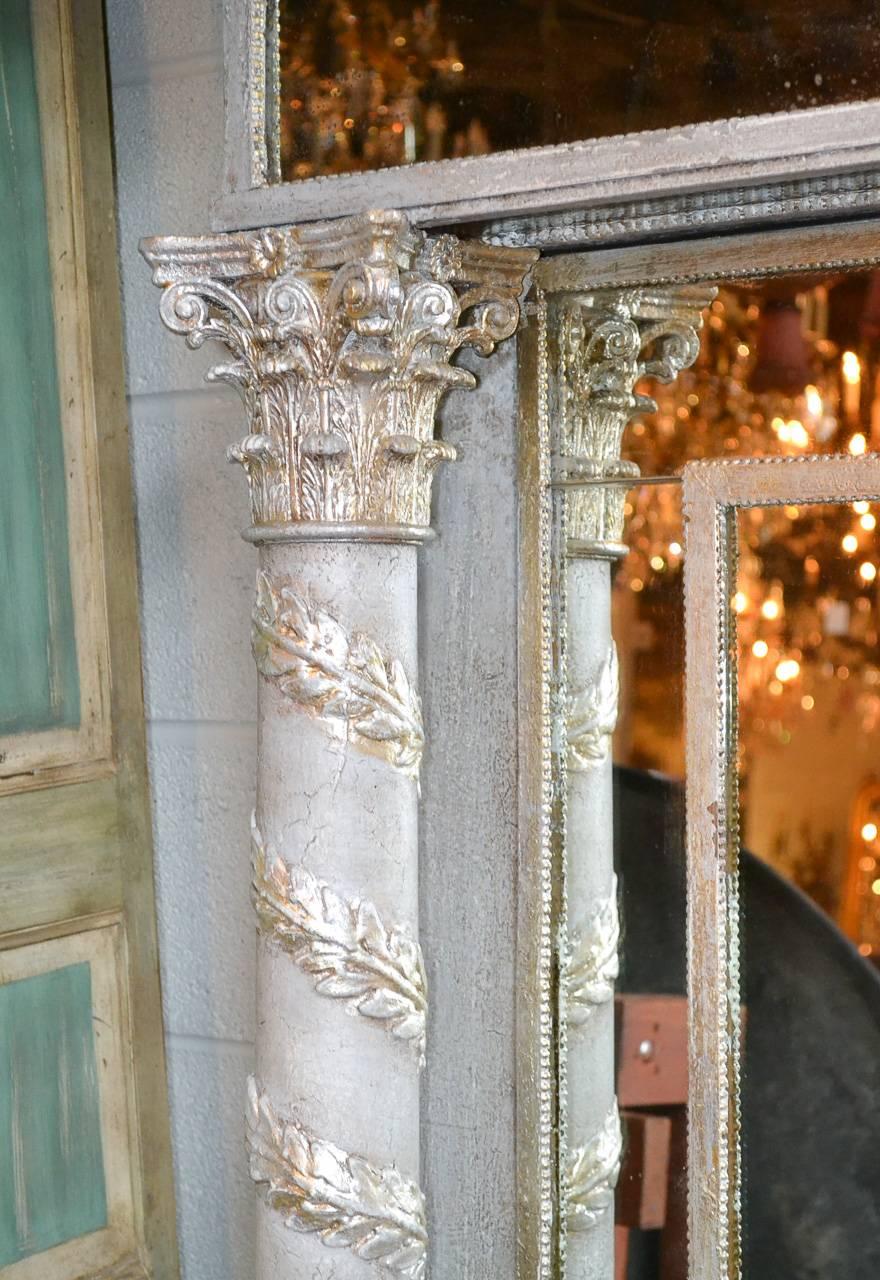 Impressive 19th century Italian painted Corinthian column mirror. Having beautifully carved columns with spiralling laurel motif, beaded inset border, and stylish later painted finish with silver leaf accents.
