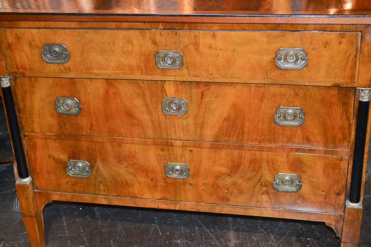 Sensational 19th century Continental walnut and ebony three-drawer commode. Having lovely ebony columnar supports, beautiful rich warm patina, and clean lines that work in countless styles of decor. Fabulous for numerous designs!
