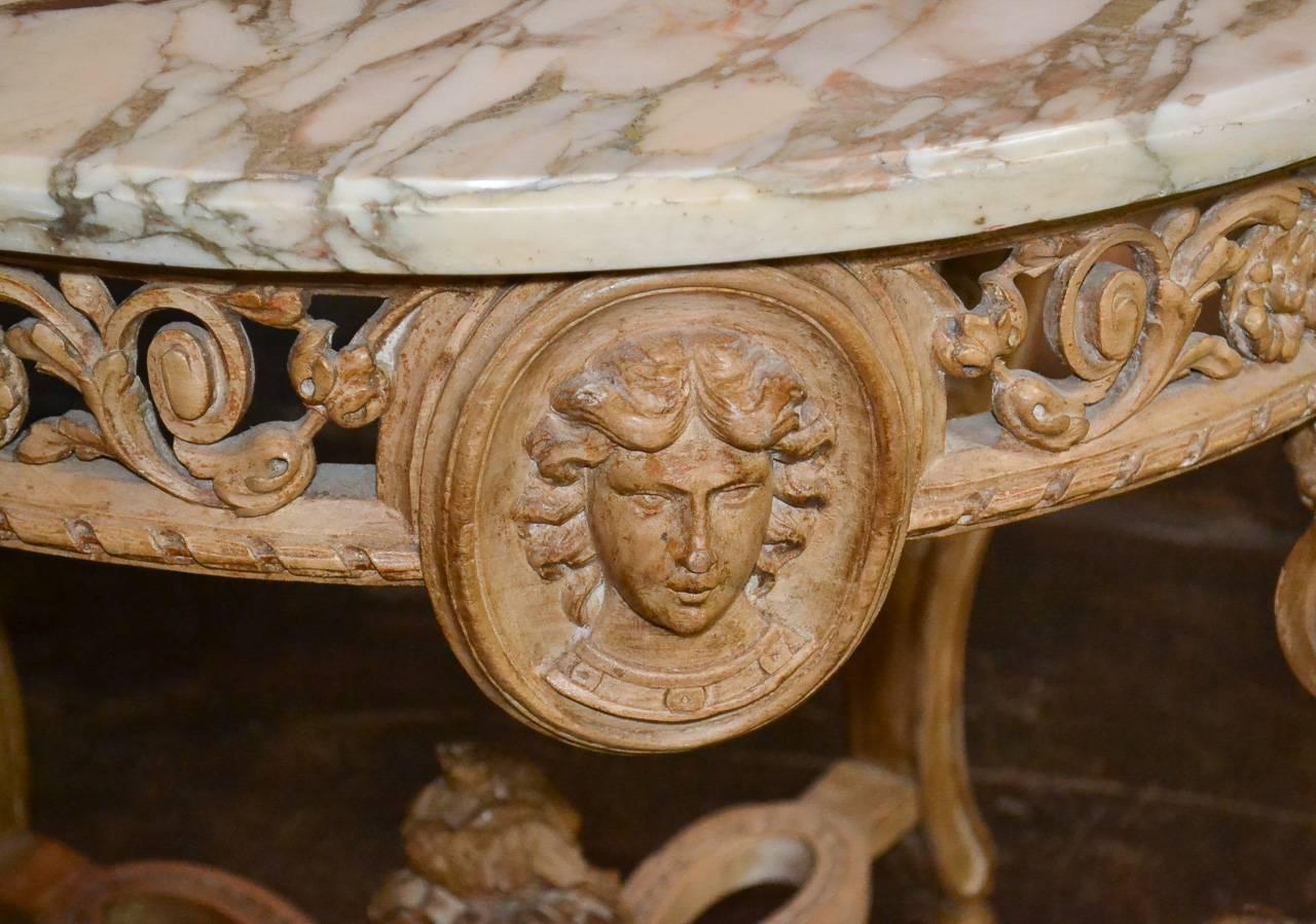 Splendid 19th century English ram's head limewood center table.  Having wonderful carved and reticulated apron with masks, detailed ram's head legs terminating in cloven feet, and lovely x-stretcher.  Exhibiting a beautiful patina and classic lines