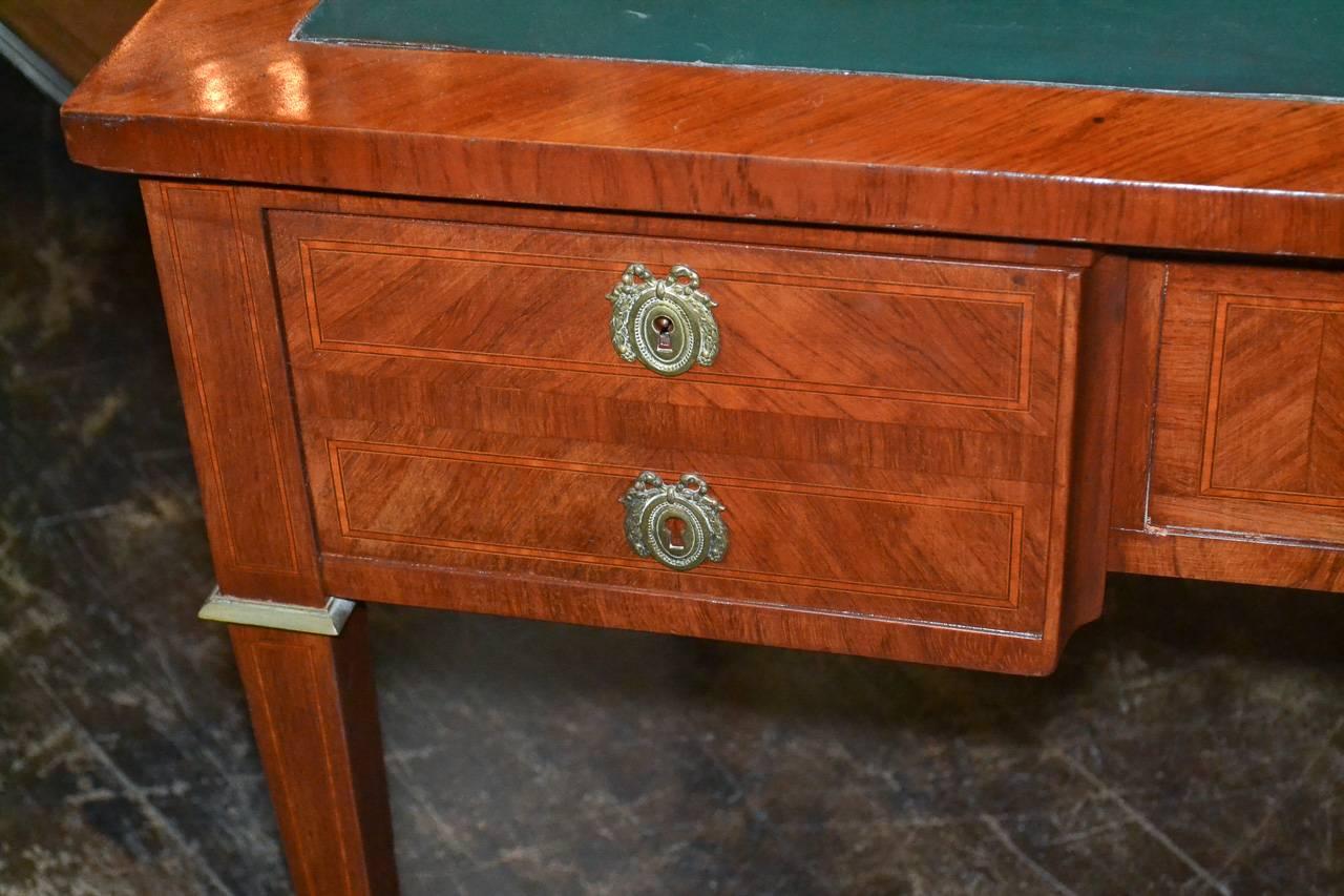 Sensational 19th century French kingwood 3-drawer writing desk.  Having gilt bronze hardware and mounts, green leather top, and resting on tapered legs.  Exhibiting crisp lines perfect for many types of decor!
