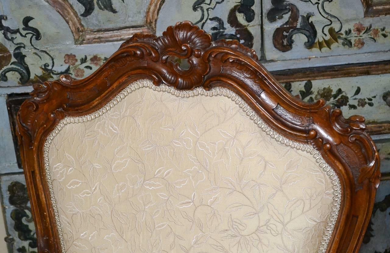 Marvelous large-scale pair of 19th century French Louis XV Rococo armchairs. Having lovely carved walnut frames, magnificent silk upholstery, and gorgeous patina. Fabulous for numerous designs!
 