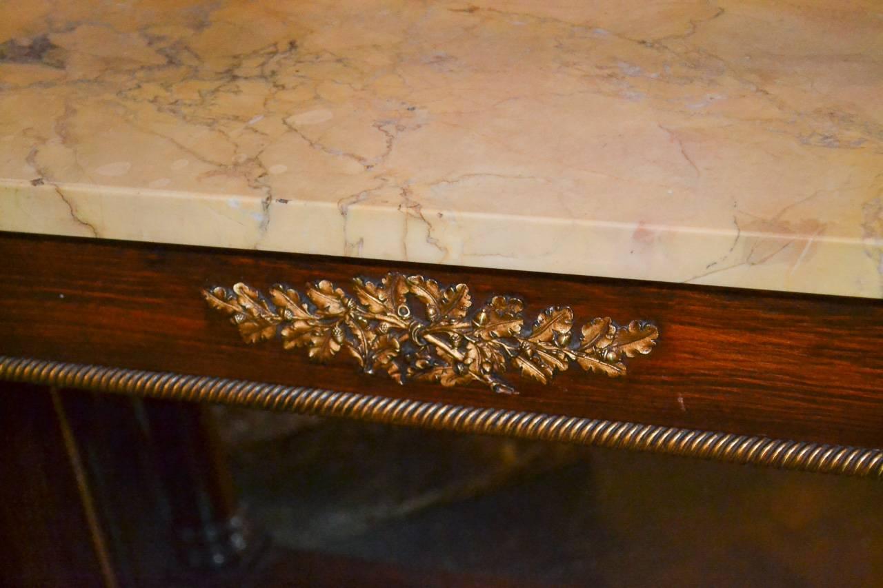 Excellent 19th century French Empire mahogany console. Having attractive gilt mounts and trim, mirrored back, and lovely Sienna marble top.   Nice clean lines to suit a variety of decorative styles!  One available.   