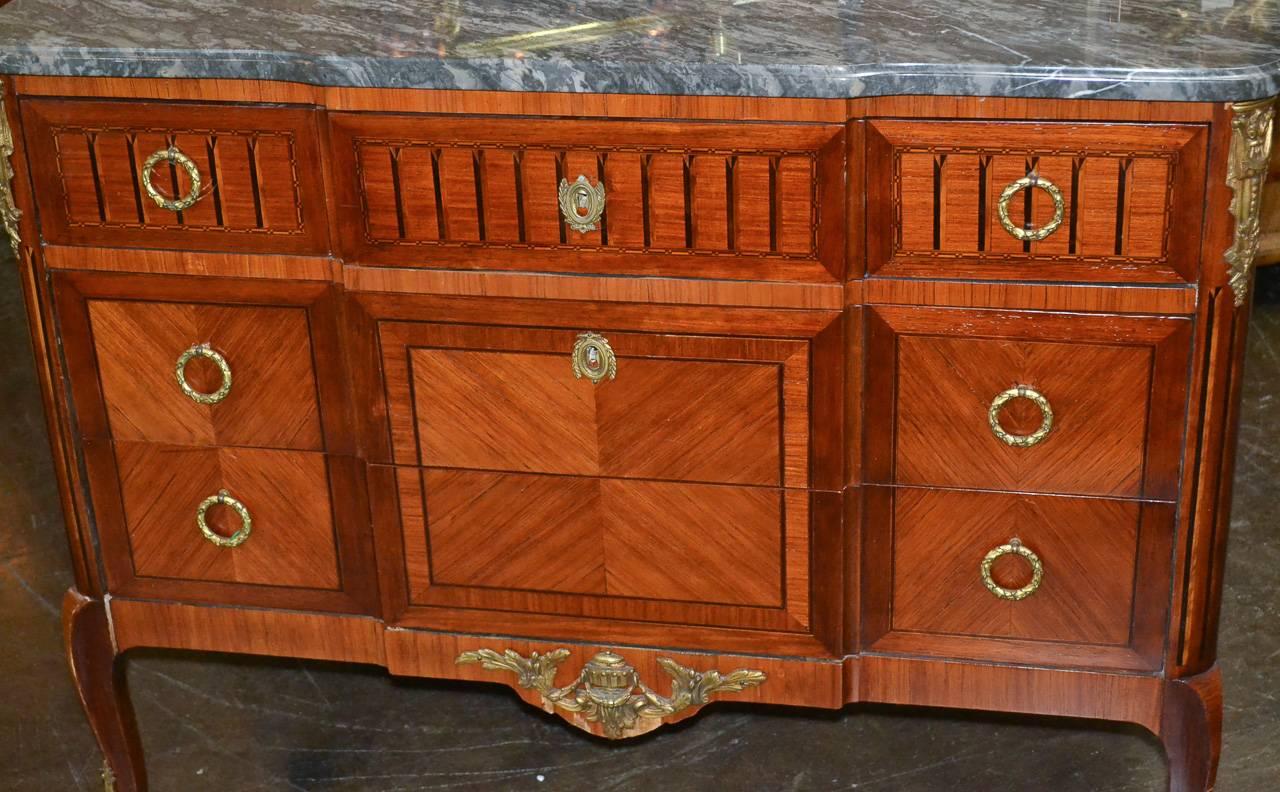 Sensational 19th century French Transitional mahogany three-drawer commode. Having gilt bronze hardware and mounts, inlaid on all sides, and wonderful Campan vert marble top. A sophisticated piece with Classic lines to suit a variety of decorative