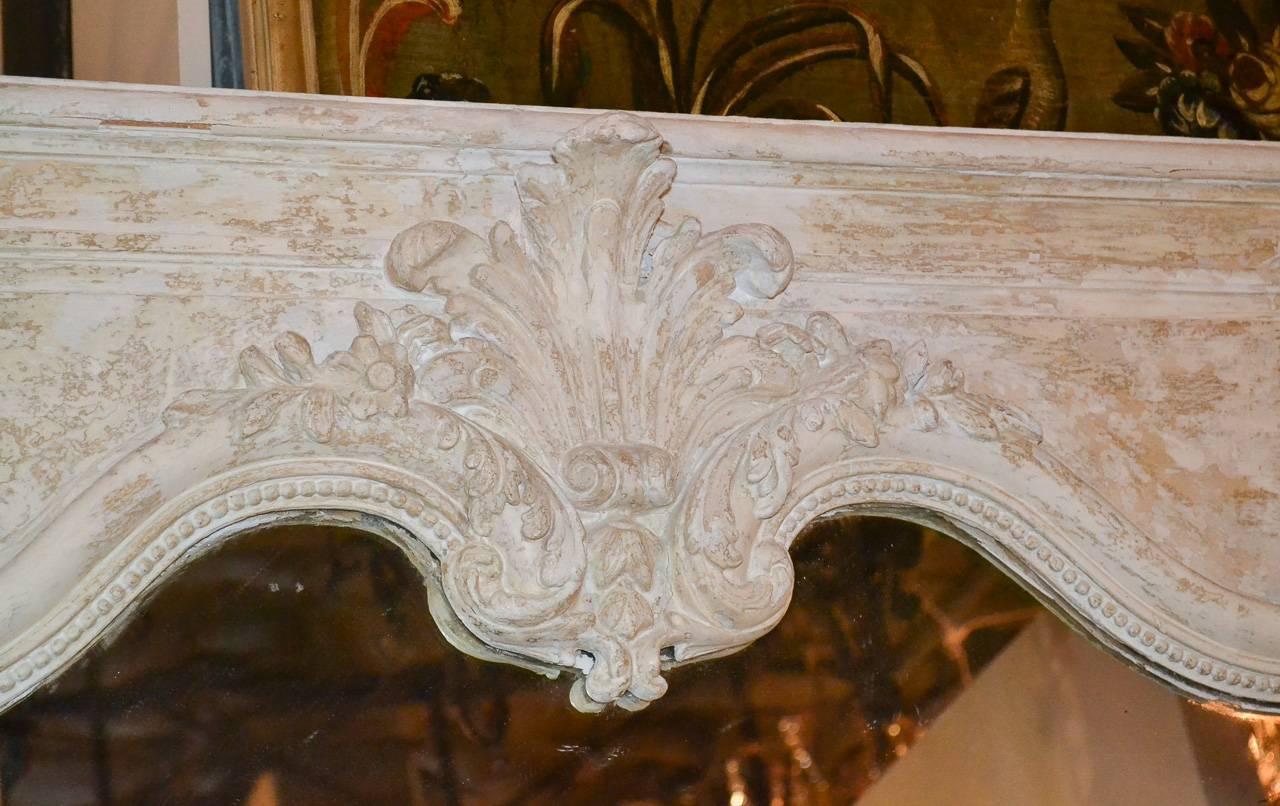 Fantastic 19th century French Regency carved and painted mirror. Having wonderful carvings in acanthus leaf motif, beaded frame, and splendid painted finish. Perfect for today's stylish decors!