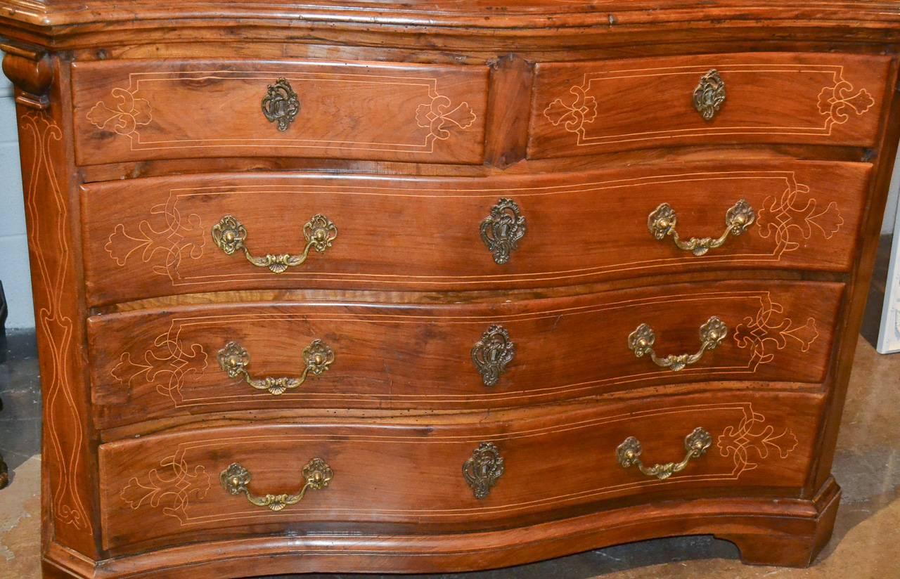 Alluring 19th century Italian walnut 8-drawer commode.  Having delicate bone inlays across drawer fronts and top, heavy bronze hardware, and gorgeous aged patina.  A wonderful piece for many designs!