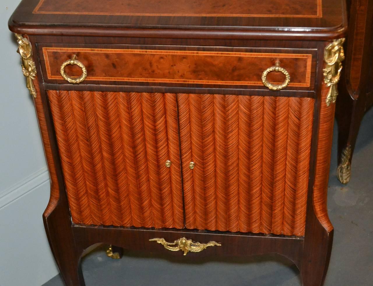 Excellent pair of French Transitional 1-drawer over 2-door mahogany side tables.  Having lovely classical gilt bronze mounts, stylish inlays, and resting on elegant tapered legs.  Wonderful for numerous designs!