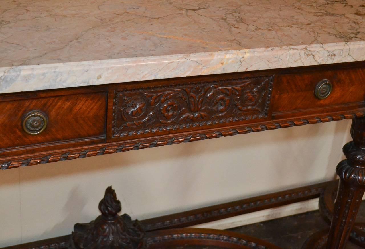 Beautiful French Louis XVI three-drawer console. Having wonderful carved walnut detailing, thick Rose de Brignoles marble top, and lovely designed stretcher. A great quality piece that would suit many types of decor!