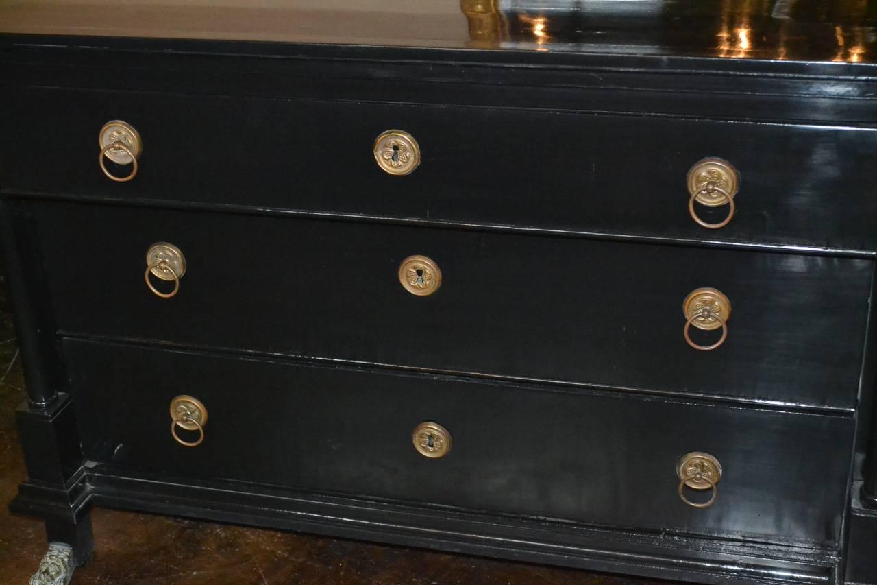 Marvelous 19th century Austrian Empire three-drawer commode. Having stylish black lacquered finish, handsome columnar supports, and wonderful bronze hardware and lion form feet. Perfect for today's stylish decors!