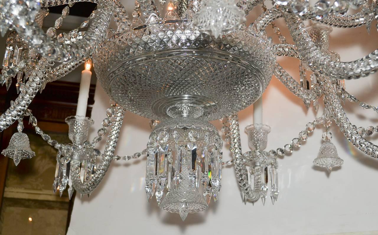 Magnificent French Baccarat twelve-light crystal chandelier. Having gorgeous cut crystal column, gracefully curved arms, beautifully adorned crown, and elegant draped beaded crystal strands. Beyond chic for numerous designs!