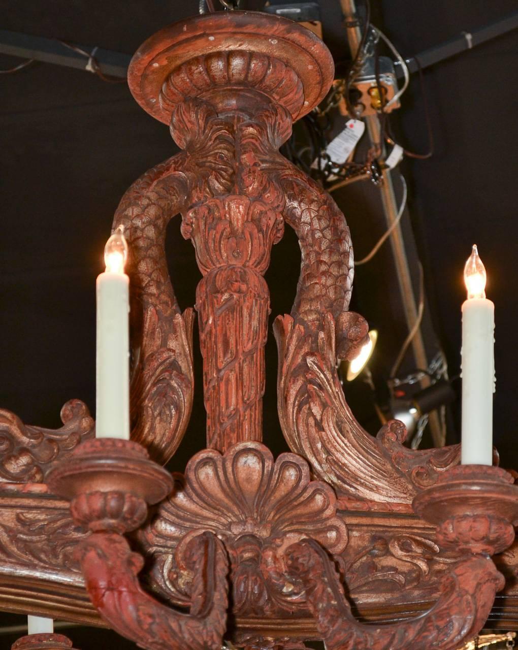 Wonderful 19th century Italian carved ten-light chandelier. Having graceful curved arms, carved dolphin adornments, and a rich warm patina. Great for numerous designs!