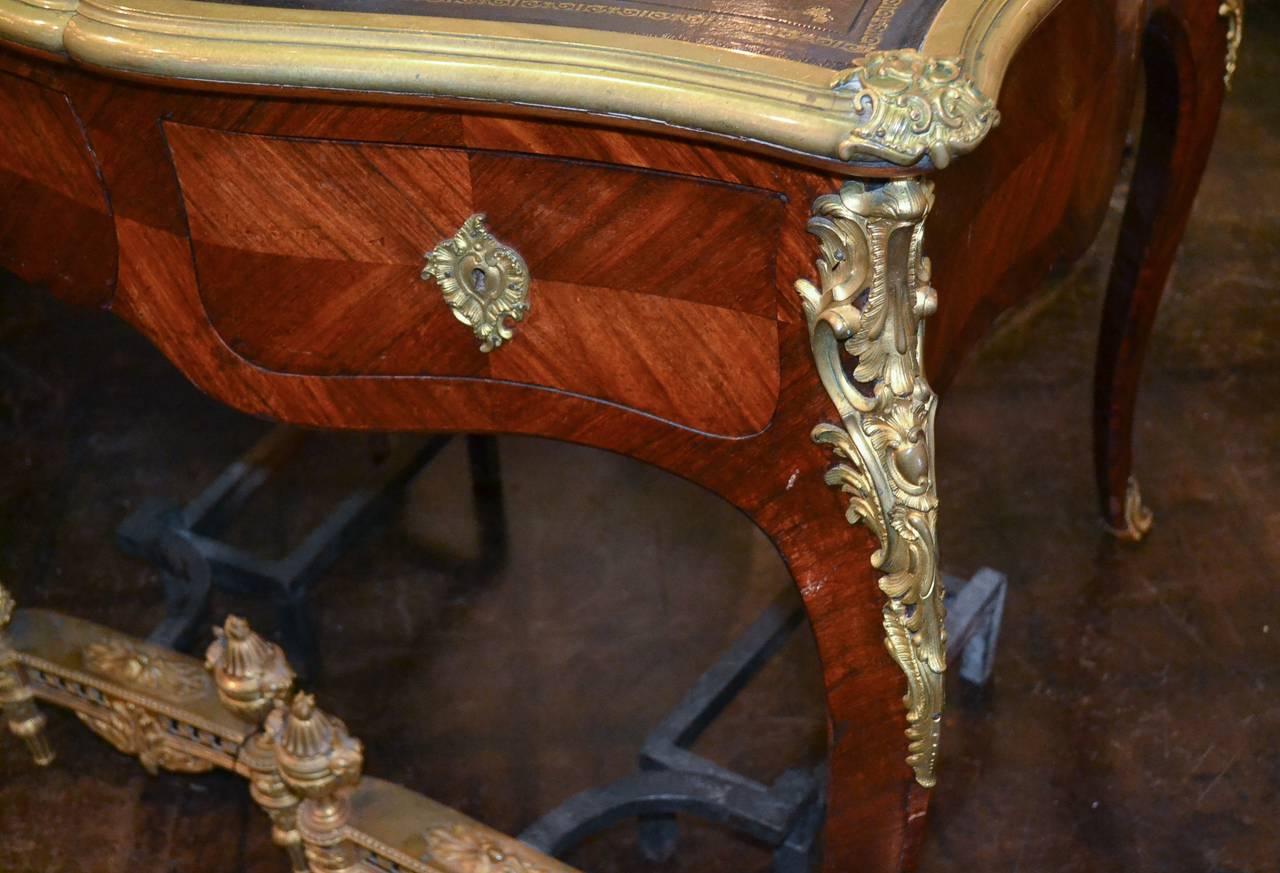 Marvellous French Louis XV kingwood and gilt bronze bureau plat. Having three drawers, lustrous gilt bronze mounts and trim, tooled leather top and resting on cabriole legs. Wonderful for numerous designs!