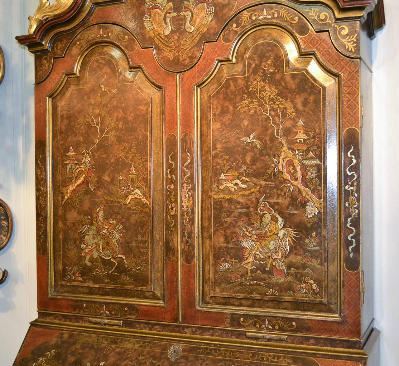 Splendid English chinoiserie tortoise lacquered bureau bookcase with shaped front. Having stunning red fitted interior and decorated in Classic oriental motif. 