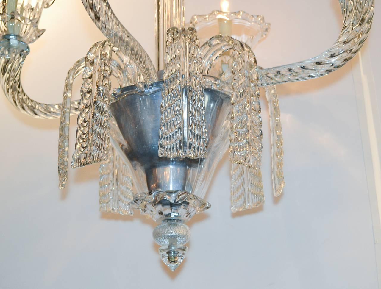Stunning French heavy glass four-light chandelier. Having graceful arms terminating in large candle cups, impressive central column, and beautiful waterfall swag prisms. 