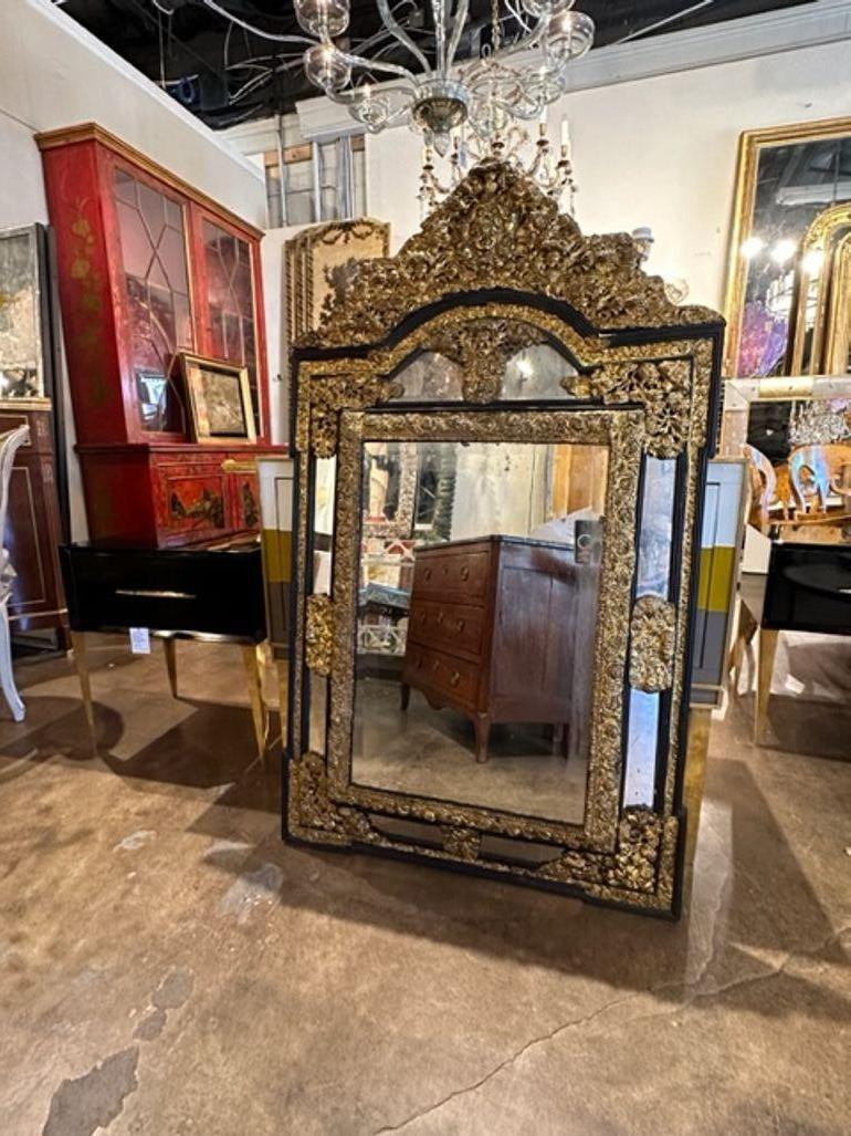 Exceptional 19th century French Napoleon III brass repousse' cushion mirror. Circa 1850. Adds warmth and charm to any room!