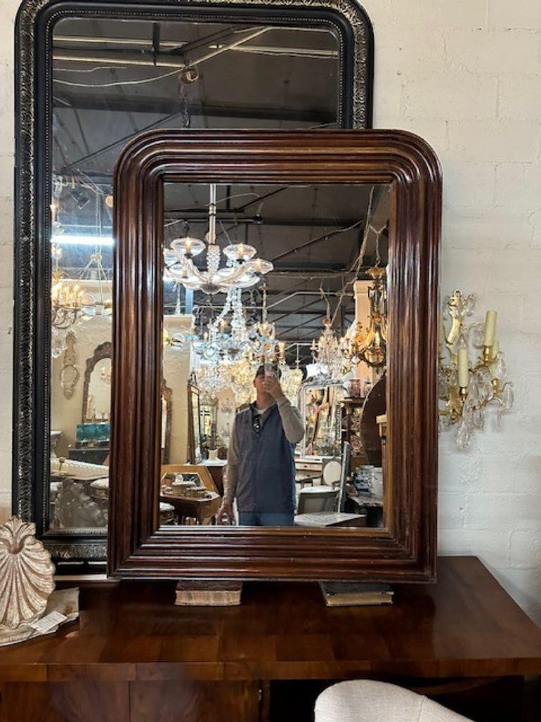 19th century French heavy carved walnut Louis Philippe design mirror. Circa 1880. Sure to make a statement!