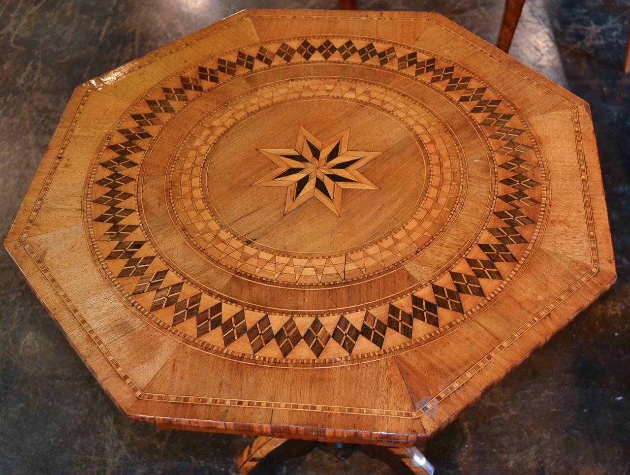 Marvelous 19th century Northern Italian multi-species inlaid side table circa 1870.  Having beautifully inlaid geometric design on table top, inlaid columnar pedestal base, shaped tripod legs, and a rich warm patina overall.