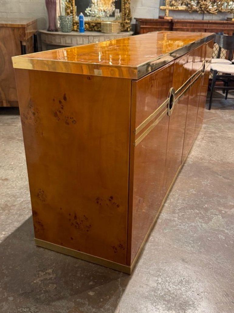 1970's Italian maple and brass sideboard after Pierre Cardin. Italian craftsmanship and Pierre Cardin’s sculptural modernism, and there are some striking examples that channel his signature style. These sideboards are perfect for anchoring a dining