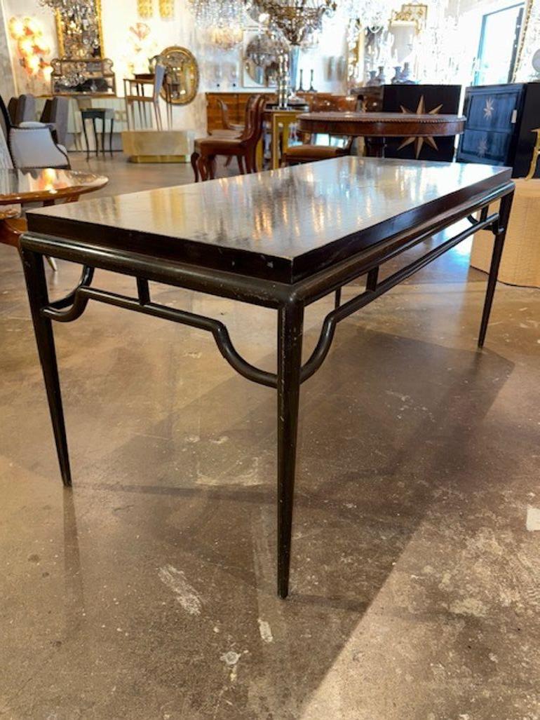 Vintage black steel coffee table after designer Tommy Parzinger. His tables are all about sculptural elegance and mid-century glamour.  Circa 1970. 54L x 24.5W x 24H
