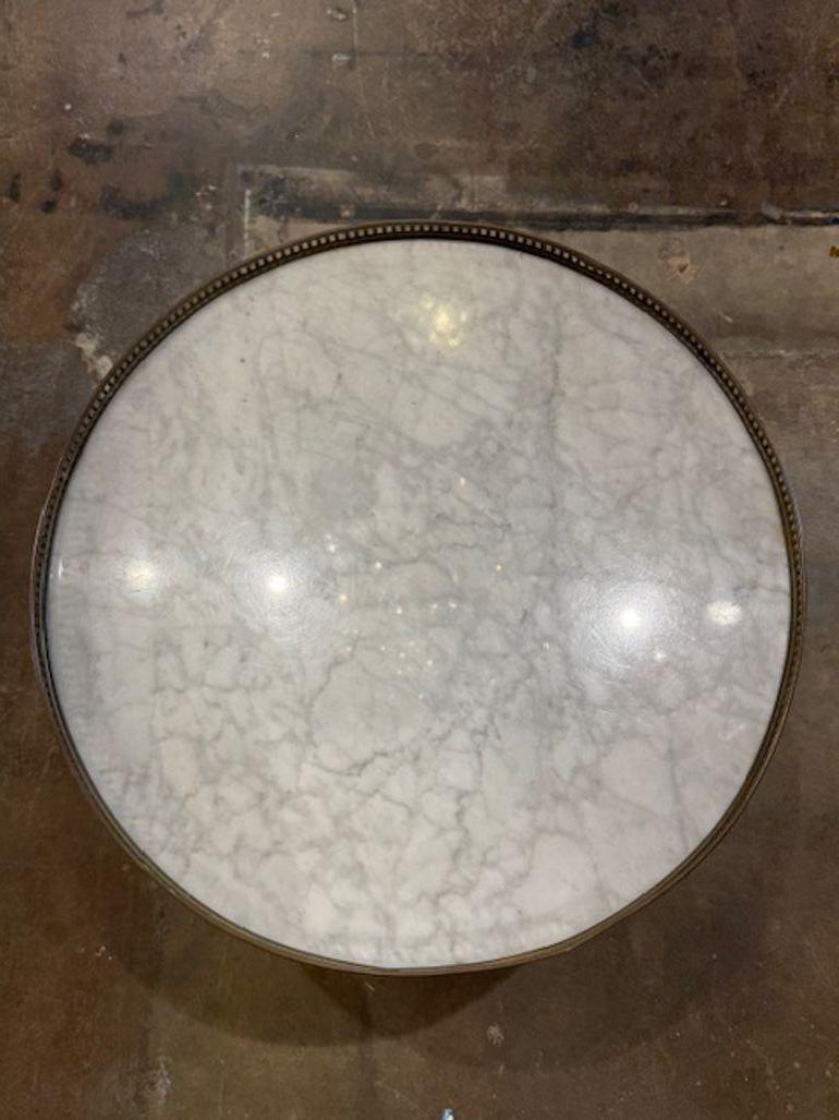 Late 19th century French Directoire' walnut and brass bouillotte table with Carrara marble top. A French Directoire' bouillotte table is a timeless piece that blends neoclassical elegance with practical charm—especially when crafted from walnut,