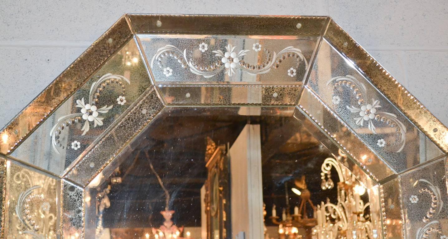 Sensational pair of Venetian etched glass octagonal mirrors. Having beveled mirrored glass, etched boarders in floral and leaf motif and a beautiful antique patina. Beyond chic for numerous designs!

 
