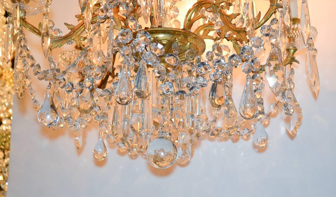 Gorgeous 19th century French Baccarat eight-light chandelier. Having lustrous doré bronze frame, scrolling arms in foliate motif, and adorned with thick beaded crystal strands and drop prisms.
 