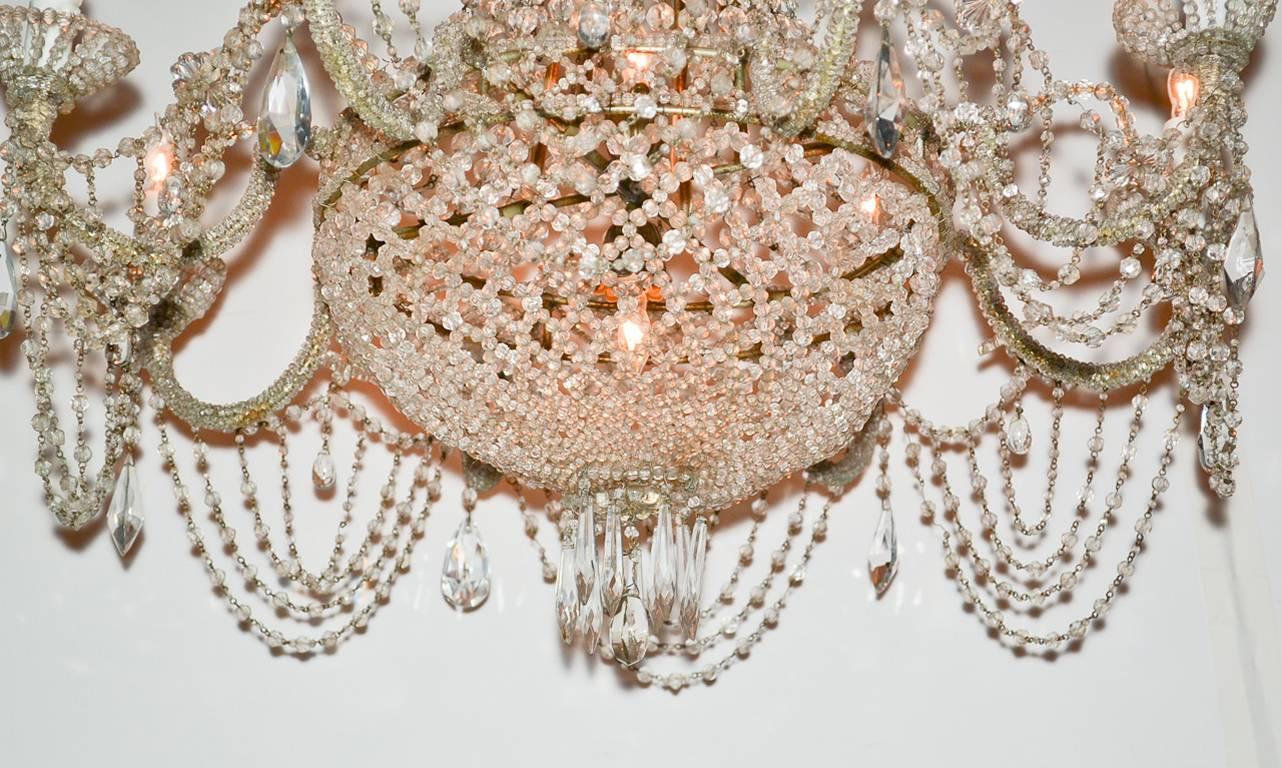 Fine Italian beaded crystal eight-light basket chandelier. Having exquisite beading overall from crown to latticed basket, extending over curved arms and terminating in unique beaded bobeche. A magnificent piece with Classic lines.