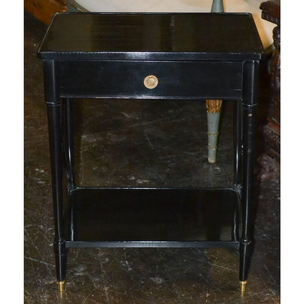 Beautiful pair of French Directoire style side tables.
Glossy black lacquered wood and brass trim,
circa 1940.