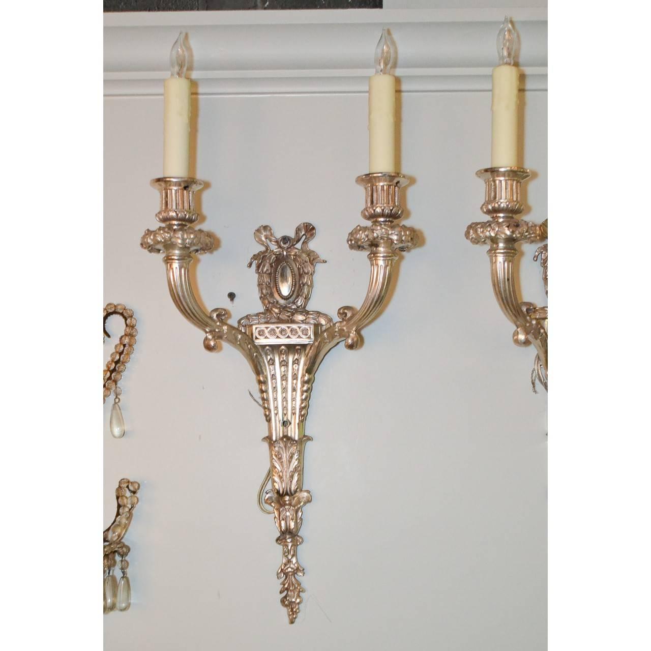 Silver over bronze pair of sconces, circa 1900.
Measures: 22