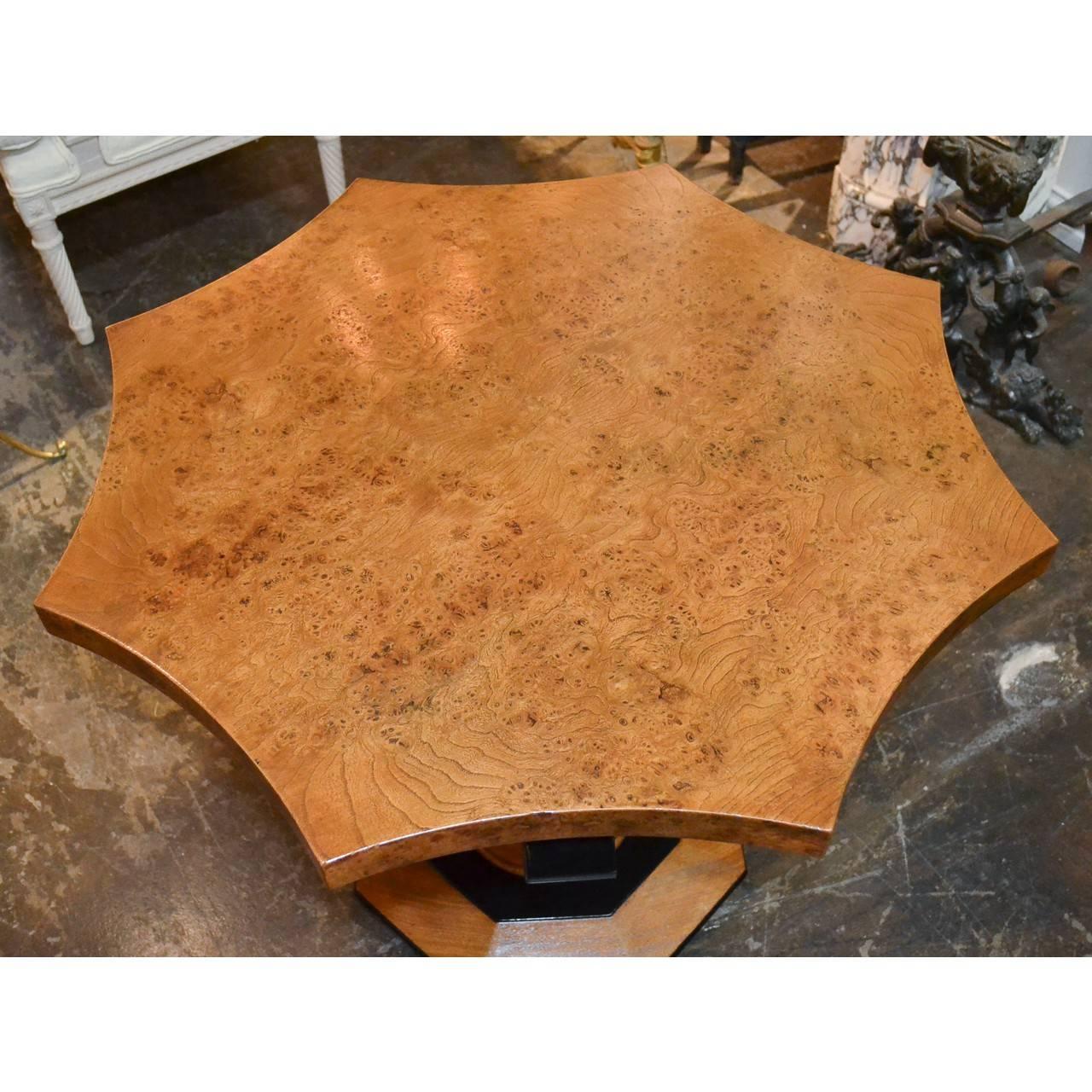 Midcentury continental burl wood table with ebonized trim.