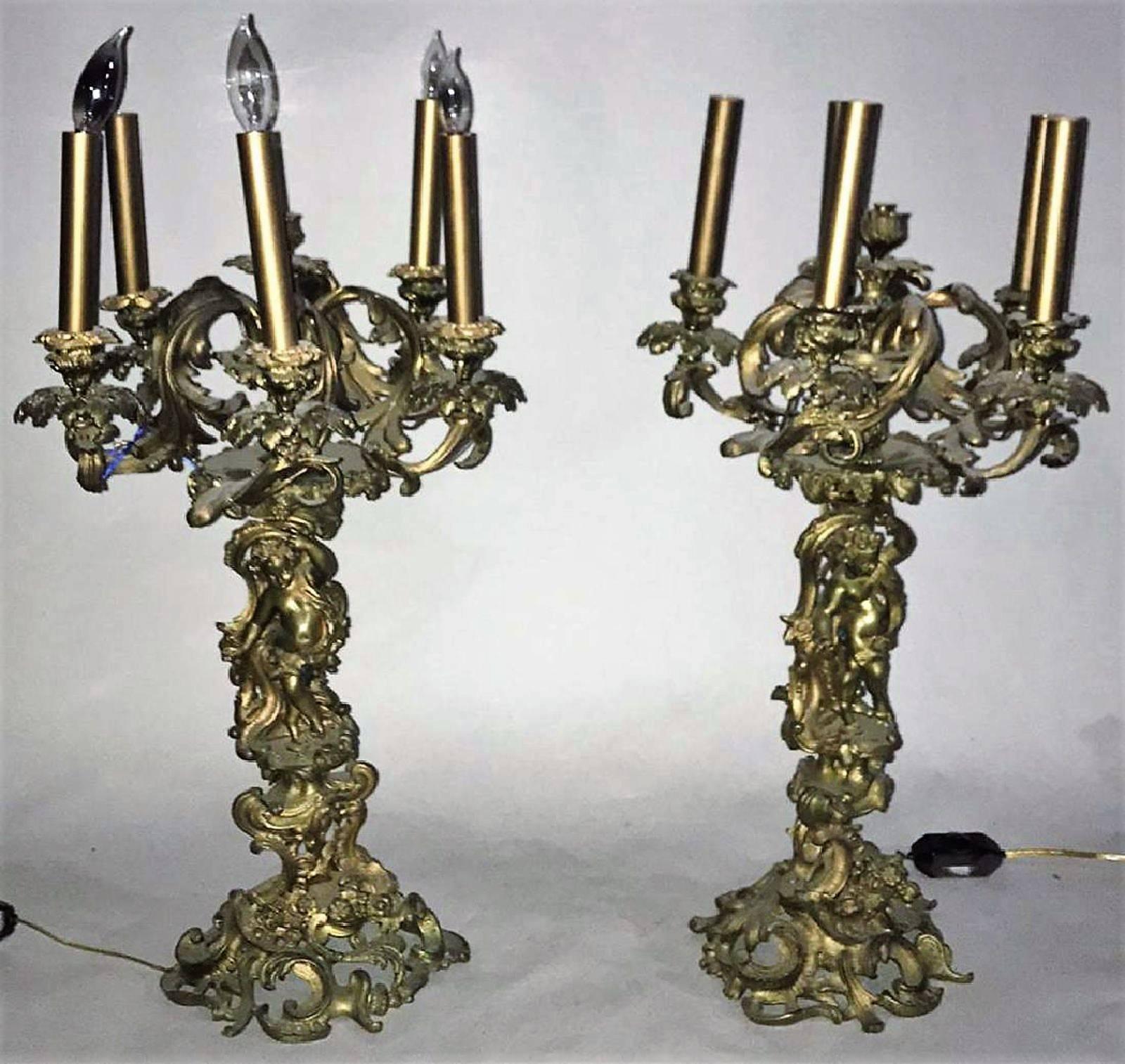 Superior pair of 19th century French Louis XV style bronze doré candelabra.

Each stem is surmounted by gold-gilded acanthus leaf scrolled arms with 6-lights above a full cherub and ornate base designed in the Rococo fashion,

circa: 1870