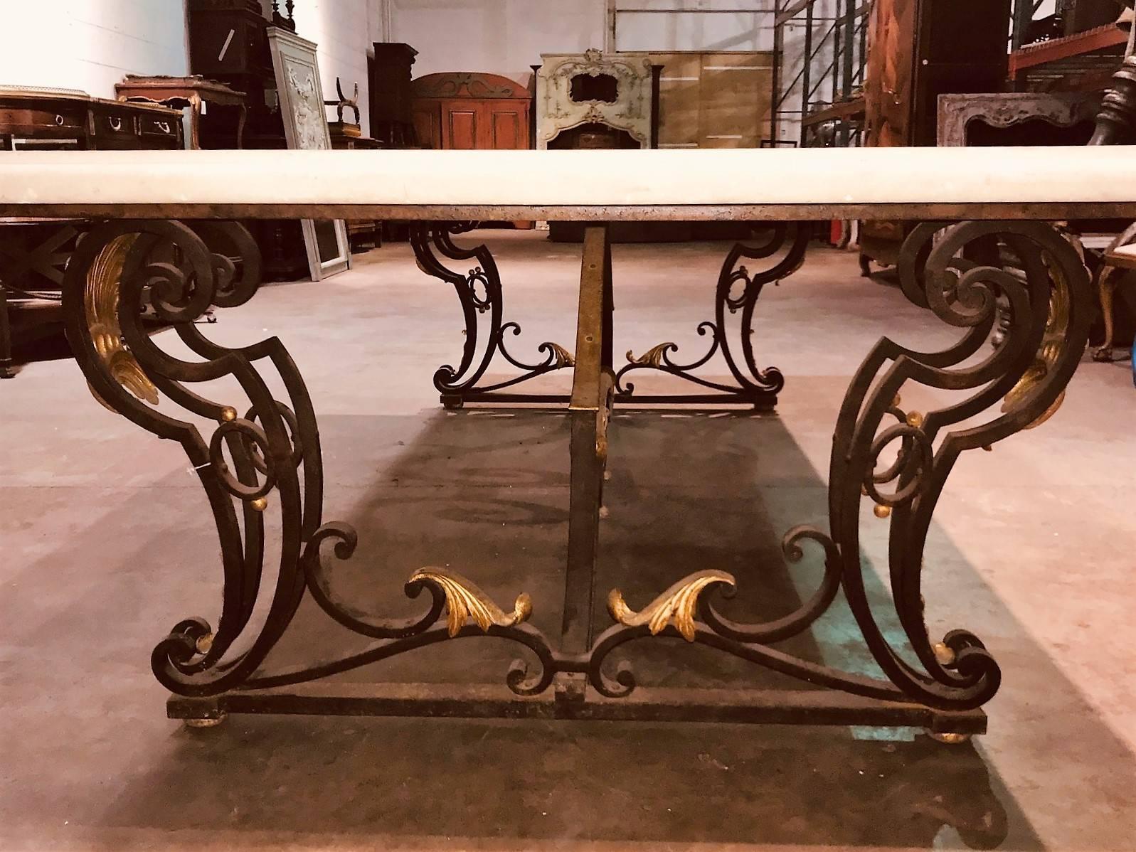 Monumental sized French designed hand-wrought iron and limestone top rectangular table.

The contoured legs and stretcher finely appointed with gold-gilded acanthus leaf accents.

The limestone is 2 inches thick and is one