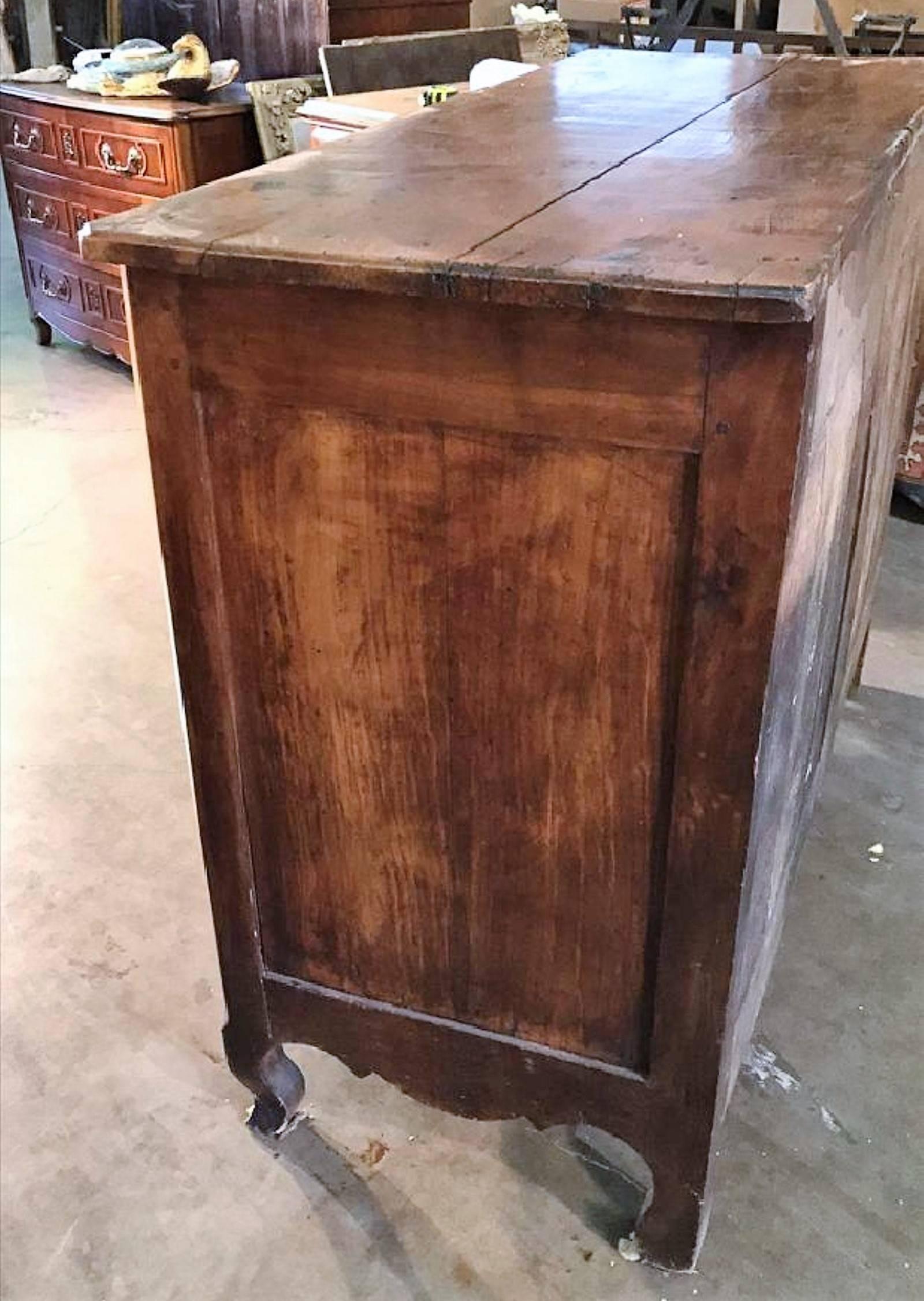 Wonderfully aged 18th century French Provincial or Country French cherry wood buffet or server.

The two drawer frieze above two cupboards with shaped inset panels. The skirt nicely shaped and hand-carved. The entire on cabriole
