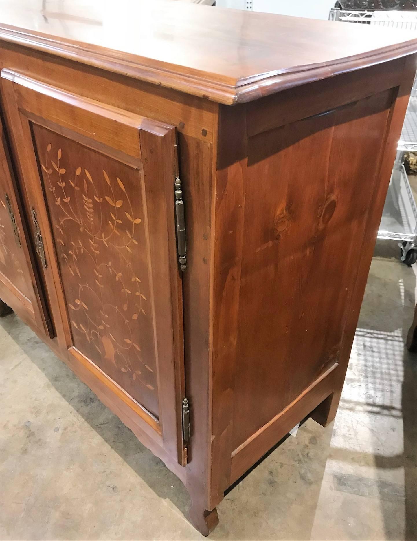 Finely crafted custom-made pair of French Provincial style cherrywood servers or buffets. The cupboard doors expertly inlaid with satinwood and done in a leaf spray motif.

Each with a shaped and carved skirt and retains the original hand-wrought