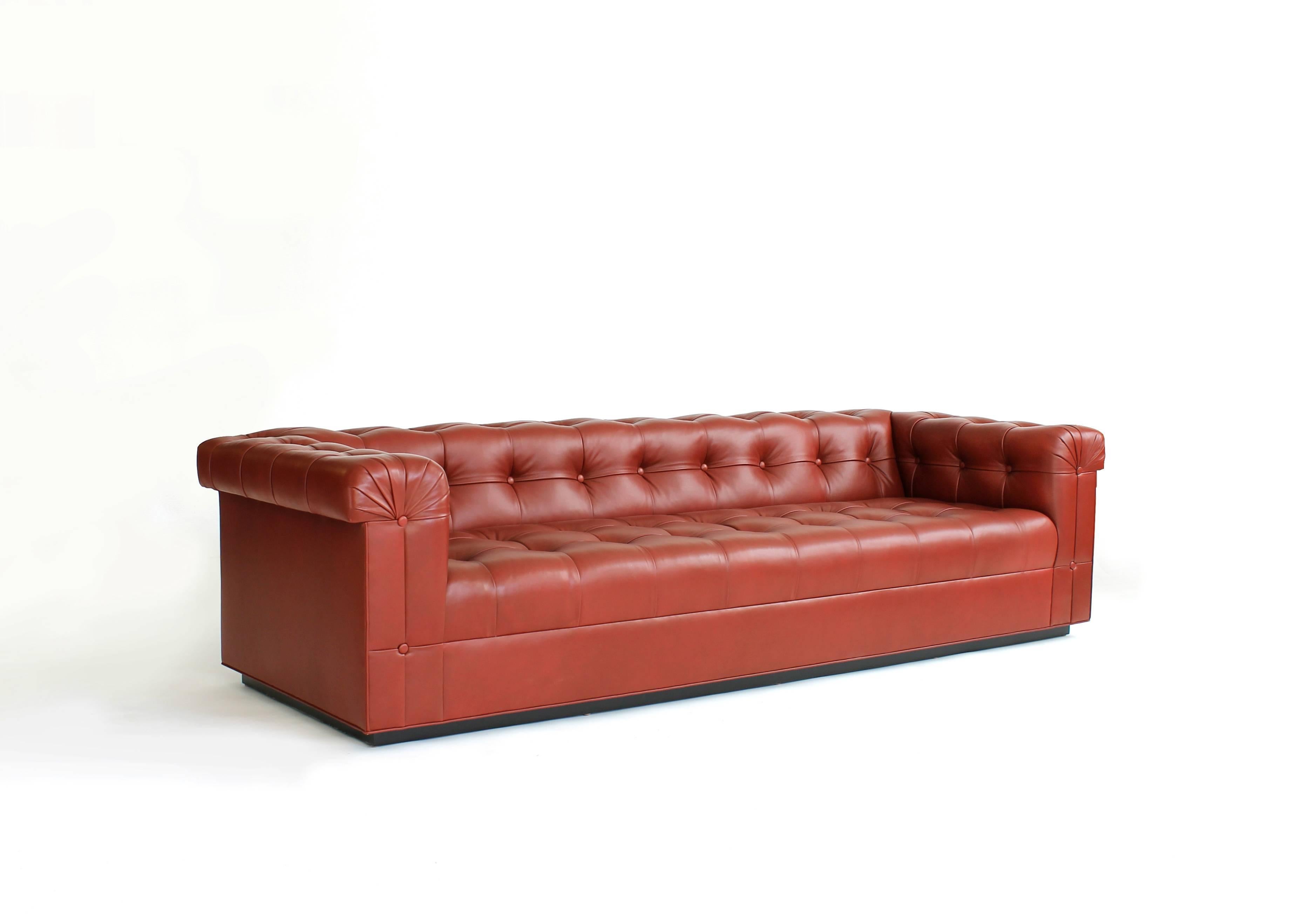 This custom sofa was made for new order by one of Chicago's finest furniture makers. It is loosely based on the Edward Wormley Party sofa. Sale price is for the red floor model only.
  