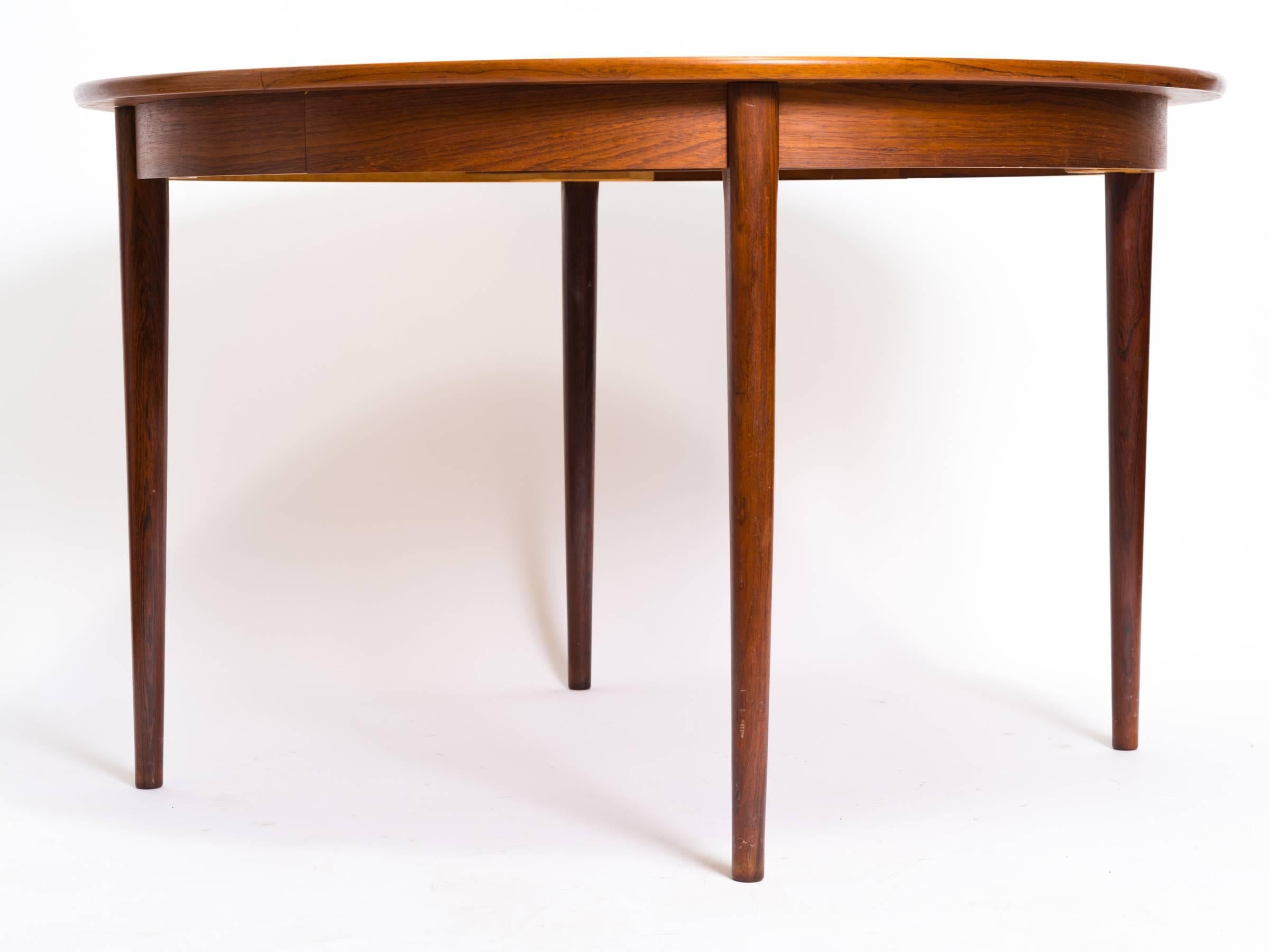Gustav Bahus rosewood dining table with two 19.5 inch leaves.

Length of table with leaves is 86 inches.