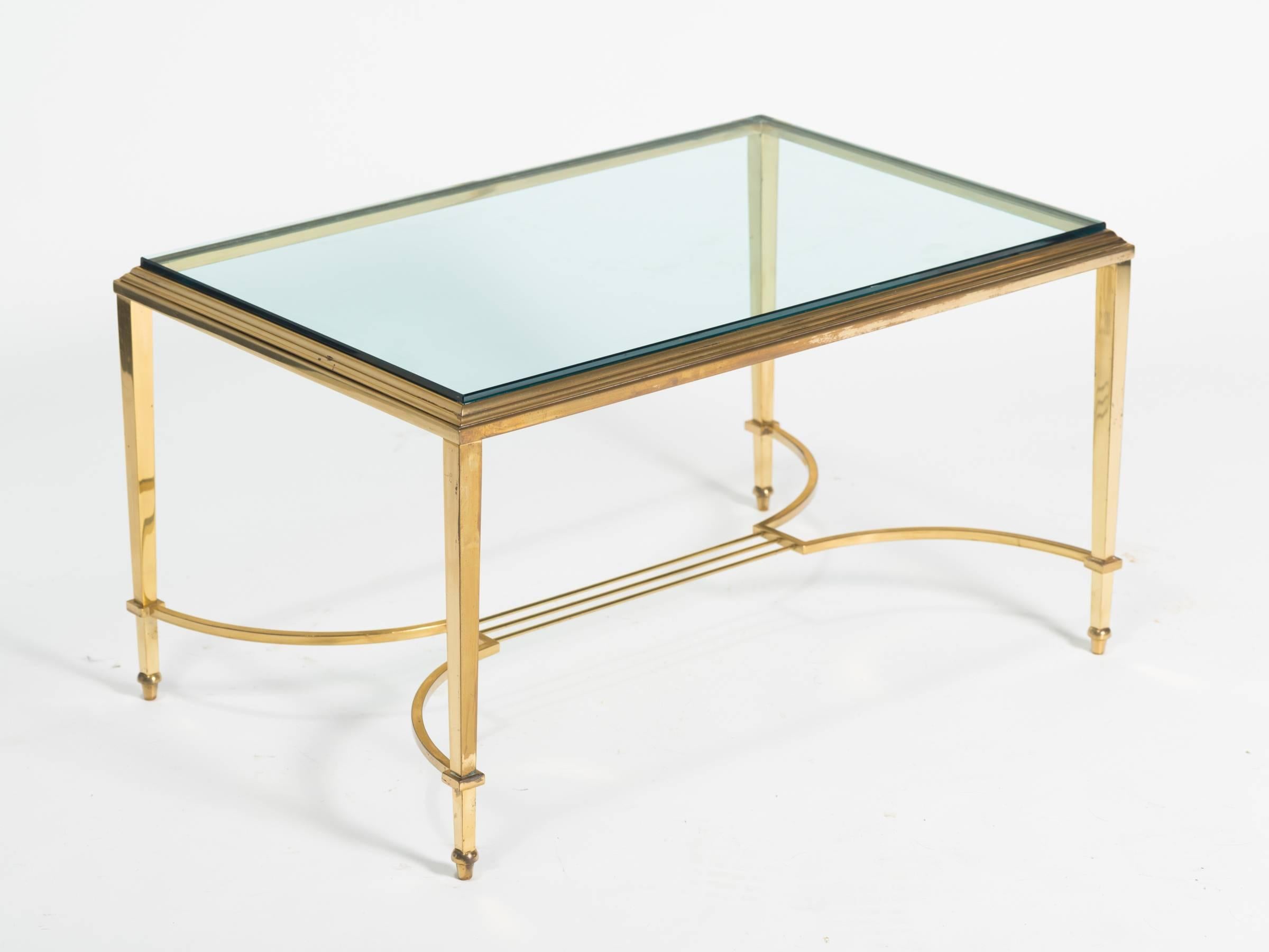 Chic Regency style thick glass cocktail table.