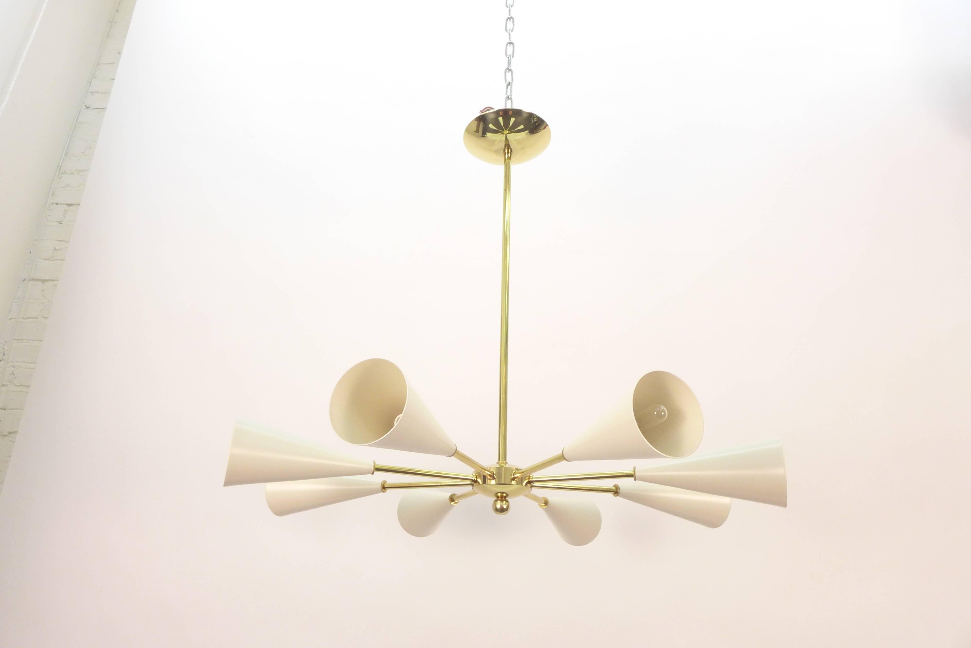 Sputnik chandelier composed of eight conical shades.
Candelabra sockets. Max 60 watt per socket.
Unlacquered brass hardware.
This model can be customized with any color and finish.