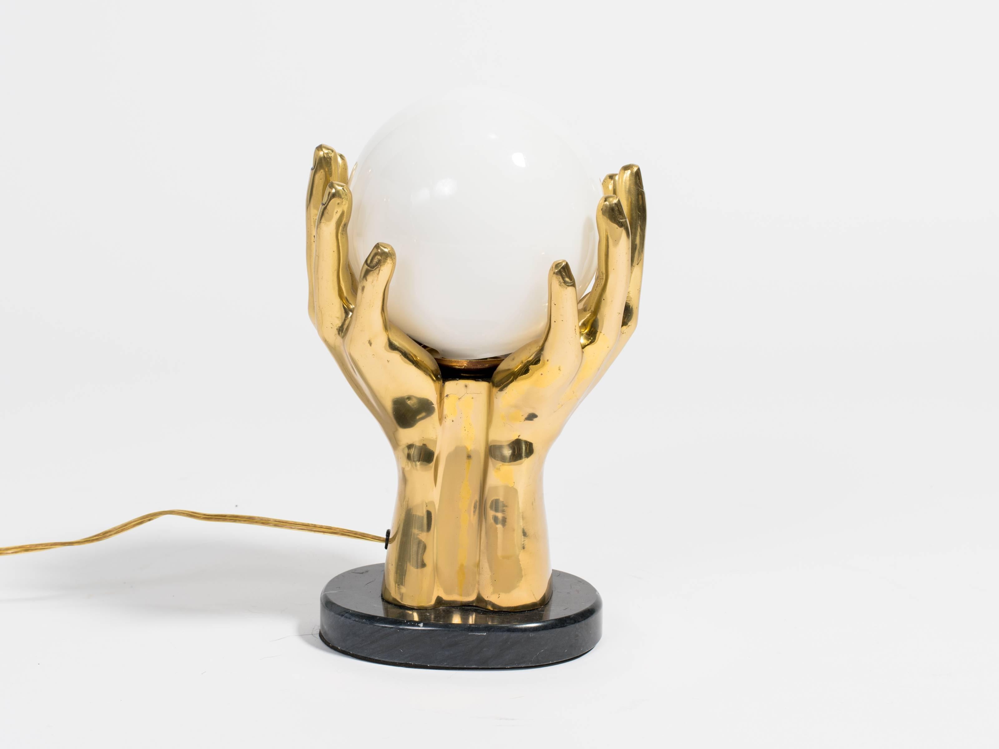Brass and marble base hand shaped table lamp.