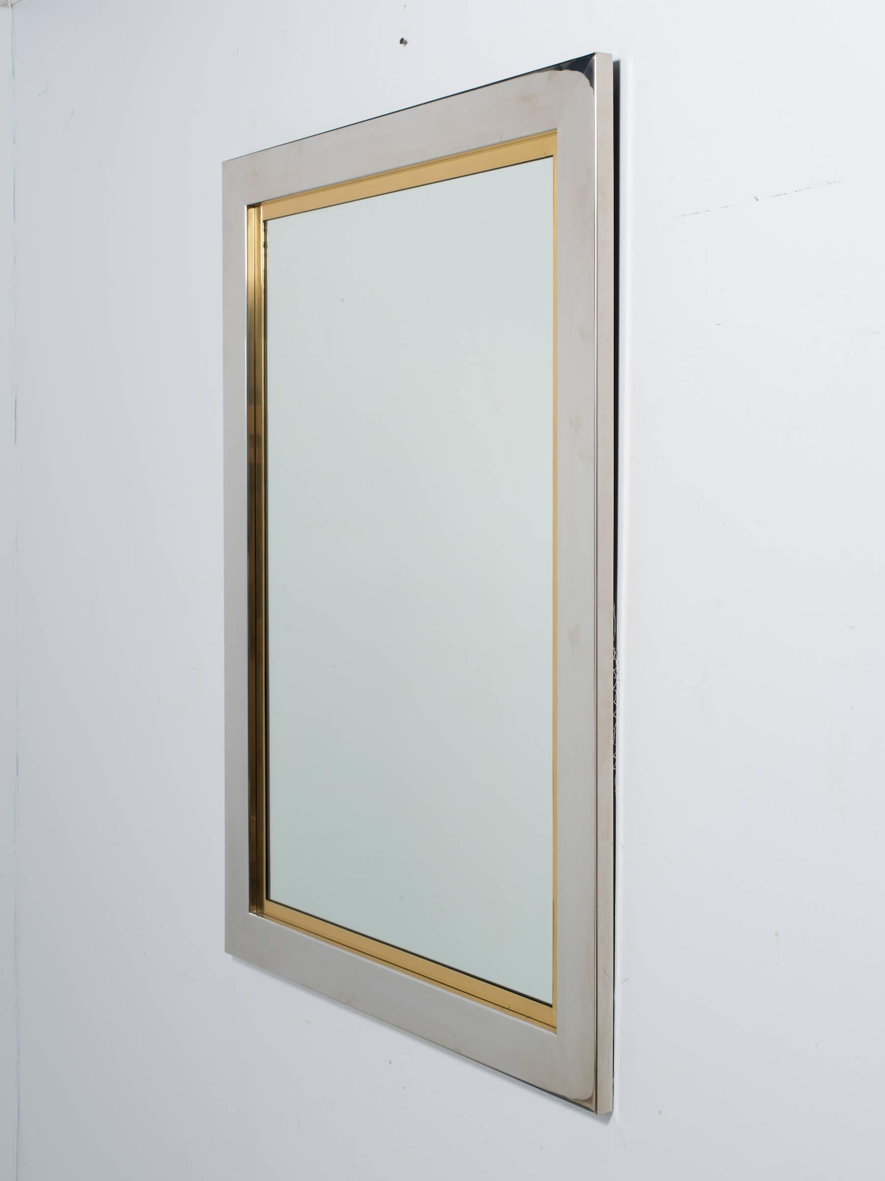 1970s chrome and brass wall mirror.