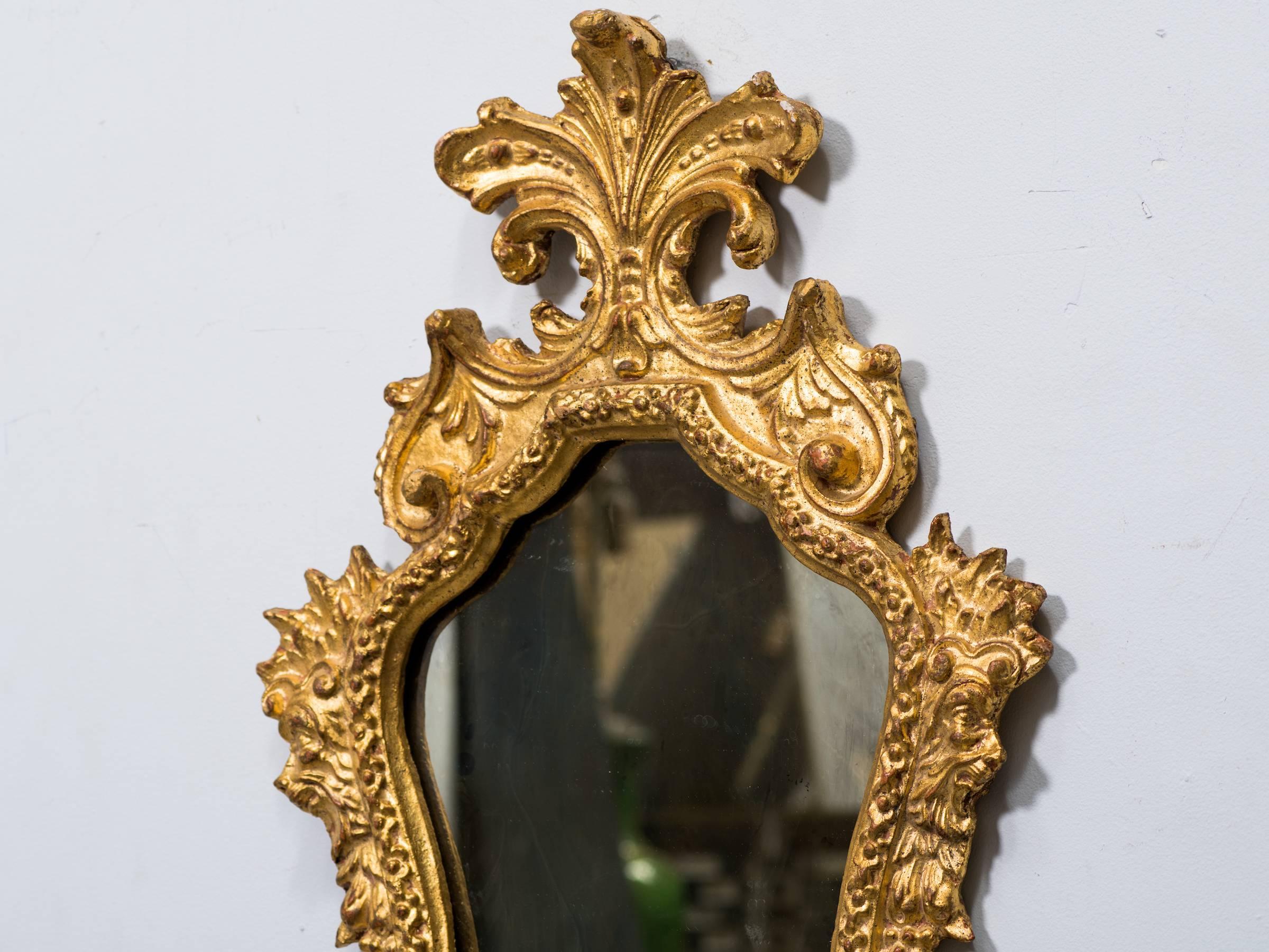 Pair of 1940s Italian carved giltwood mirrors with antiqued glass.