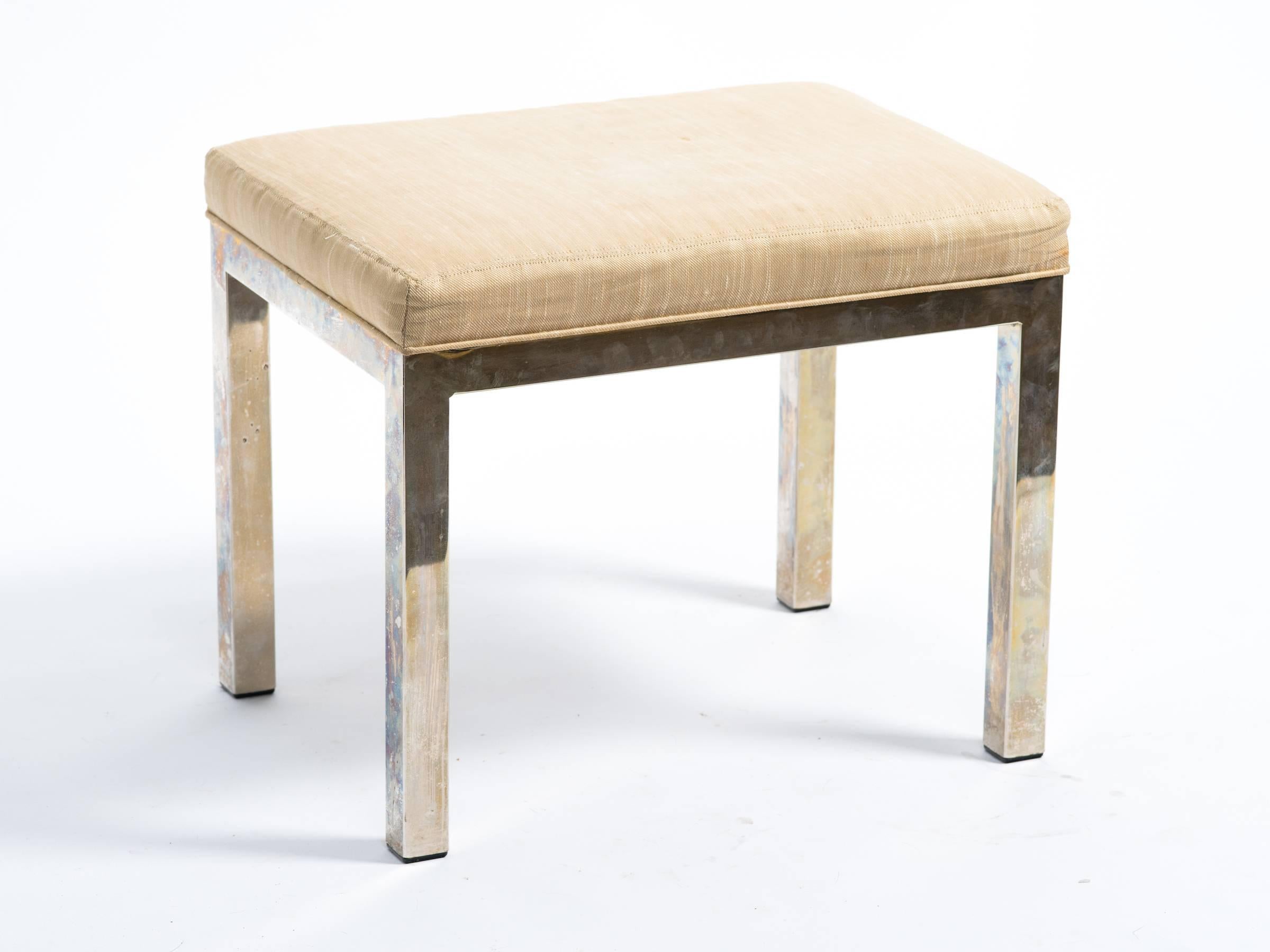 Chrome bench with brass hues.