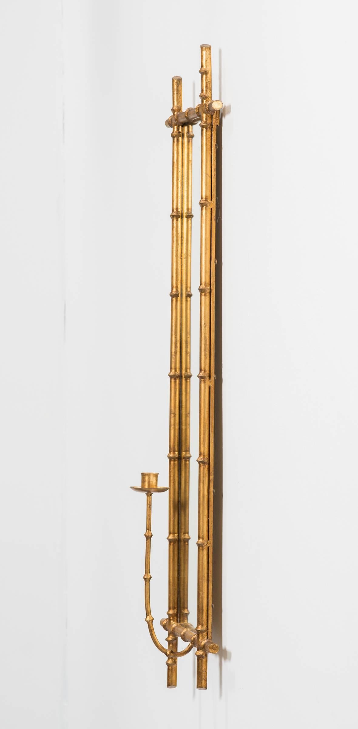 Pair of gilt metal faux bamboo mirrored candle sconces.