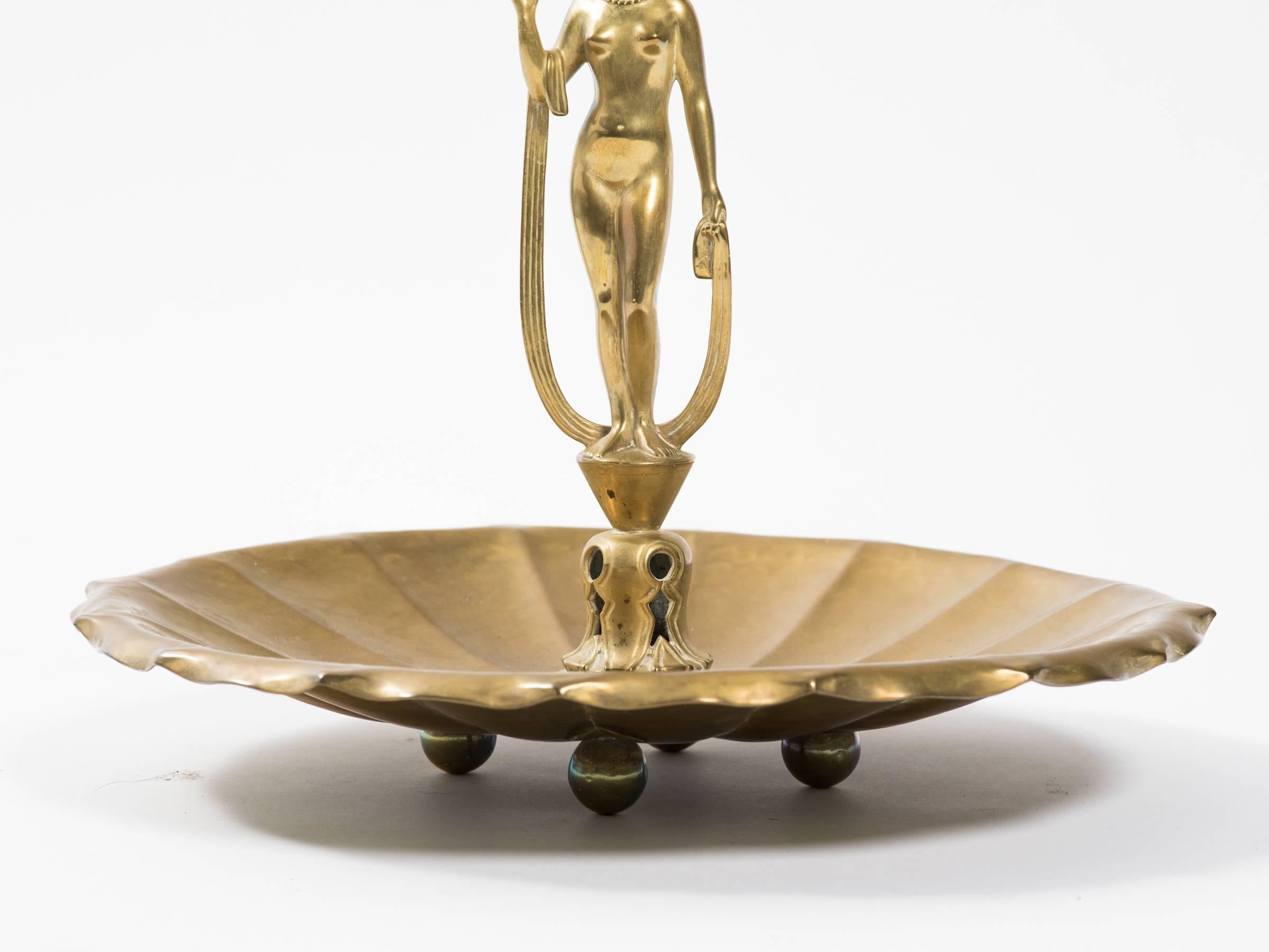 Art Deco brass figural centerpiece. Hand hammered.